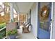 Front porch with wicker chairs and a fall wreath on the door at 30 Willow Bend Dr, Youngsville, NC 27596