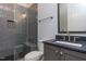 Bathroom with grey tile shower and dark vanity at 370 Bellini Dr, Clayton, NC 27527