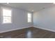 Well-lit bedroom featuring hardwood floors and two windows at 370 Bellini Dr, Clayton, NC 27527