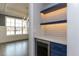 Butlers pantry with blue cabinets, quartz countertops, and wine cooler at 370 Bellini Dr, Clayton, NC 27527