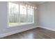 Bright dining room with hardwood floors and large windows offering abundant natural light at 370 Bellini Dr, Clayton, NC 27527