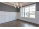 Formal dining room with wainscoting, hardwood floors, and a large window at 370 Bellini Dr, Clayton, NC 27527