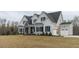 Two story home with gray siding, stone accents, and a two-car garage at 370 Bellini Dr, Clayton, NC 27527