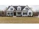 Two story home with gray siding, stone accents, and a landscaped lawn at 370 Bellini Dr, Clayton, NC 27527