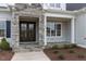Elegant front entrance with double doors, stone accents, and a covered porch at 370 Bellini Dr, Clayton, NC 27527
