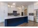 Modern kitchen with white cabinets, a large island, quartz countertops, and stainless steel appliances at 370 Bellini Dr, Clayton, NC 27527
