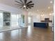 Open floor plan with kitchen, island, and living area with hardwood floors and access to a screened porch at 370 Bellini Dr, Clayton, NC 27527