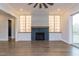 Bright living room showcasing a fireplace with hexagonal blue tile, built-in shelving, and hardwood floors at 370 Bellini Dr, Clayton, NC 27527