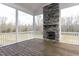 Relaxing screened porch with stone fireplace and wood flooring at 370 Bellini Dr, Clayton, NC 27527