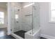 Large walk-in shower with glass enclosure and built-in seat at 370 Bellini Dr, Clayton, NC 27527