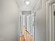 Long hallway with hardwood floors and access to bedrooms at 1526 Clermont Rd, Durham, NC 27713