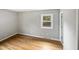 Well-lit bedroom featuring hardwood floors and a closet at 1526 Clermont Rd, Durham, NC 27713