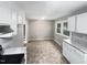 Bright kitchen with white cabinets and a view of the stairs at 1526 Clermont Rd, Durham, NC 27713