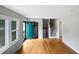 Living room with hardwood floors, stairs and green door at 1526 Clermont Rd, Durham, NC 27713
