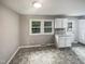 Eat-in kitchen with white cabinets and vinyl flooring at 1526 Clermont Rd, Durham, NC 27713