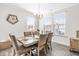 Dining room featuring a wood table and neutral-toned chairs at 52 E Piston Pt, Clayton, NC 27520