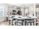 Modern kitchen with gray cabinets, quartz countertops, and island seating at 52 E Piston Pt, Clayton, NC 27520