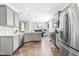 Modern kitchen with gray cabinets, stainless steel appliances, and white countertops at 52 E Piston Pt, Clayton, NC 27520