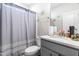 Bathroom with gray vanity, quartz countertop, and shower at 52 E Piston Pt, Clayton, NC 27520