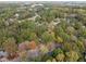 Aerial view showing a neighborhood with lush green trees and houses at 3158 Morningside Dr, Raleigh, NC 27607