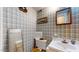 Small bathroom with sink, toilet, and patterned wallpaper at 3158 Morningside Dr, Raleigh, NC 27607