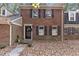 Brick front exterior of charming townhome with black door and shutters at 3158 Morningside Dr, Raleigh, NC 27607