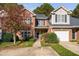 Two-story brick townhouse with a two-car garage and landscaped yard at 2106 White Pond Ct, Apex, NC 27523