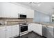 Well-equipped kitchen boasts granite countertops and white cabinetry at 2106 White Pond Ct, Apex, NC 27523