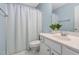 Clean bathroom with white vanity, shower, and a plant at 2106 White Pond Ct, Apex, NC 27523