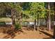 Serene pond view with a bench, surrounded by lush greenery and trees at 2106 White Pond Ct, Apex, NC 27523