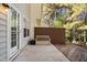 Small patio with bench and access to wooded area at 2106 White Pond Ct, Apex, NC 27523