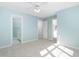 Bright bedroom with ceiling fan and access to bathroom at 2106 White Pond Ct, Apex, NC 27523