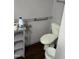 Bathroom with toilet, grab bars, and wood-look floors at 206 W Garner Rd, Garner, NC 27529