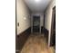 Hallway with wood-look floors and dark trim at 206 W Garner Rd, Garner, NC 27529