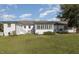 Rear view of the house, showcasing the sunroom and large backyard at 203 W Stewart St, Coats, NC 27521