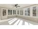 Sunroom with multiple windows and access to backyard at 203 W Stewart St, Coats, NC 27521