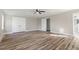 Large main bedroom with hardwood floors and double doors to the bathroom at 203 W Stewart St, Coats, NC 27521