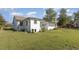 Side view showcasing the white exterior and landscaping at 203 W Stewart St, Coats, NC 27521