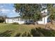 White house exterior with a sunroom and nicely landscaped lawn at 203 W Stewart St, Coats, NC 27521