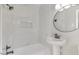 Bathroom with marble tile shower and pedestal sink at 203 W Stewart St, Coats, NC 27521