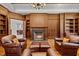 Elegant library with a fireplace and built-in wooden bookshelves at 110 Bywater Way, Chapel Hill, NC 27516