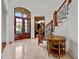 Spacious entry with tile floors, wooden staircase, and a charming table at 110 Bywater Way, Chapel Hill, NC 27516