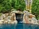 Serene waterfall cascading into a tranquil pool area at 110 Bywater Way, Chapel Hill, NC 27516