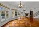 Sunlit living room boasts hardwood floors, a fireplace, and large windows at 110 Bywater Way, Chapel Hill, NC 27516