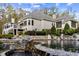 House exterior showcasing a large home with stonework and a pool at 110 Bywater Way, Chapel Hill, NC 27516