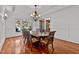 Bright dining room with hardwood floors, large windows, and a chandelier at 110 Bywater Way, Chapel Hill, NC 27516