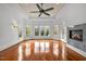 Sun-drenched living room with hardwood floors, fireplace, and access to deck at 110 Bywater Way, Chapel Hill, NC 27516