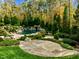 Resort-style pool with waterfall feature and stonework at 110 Bywater Way, Chapel Hill, NC 27516