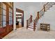 Bright and airy entryway with a staircase and wooden doors at 110 Bywater Way, Chapel Hill, NC 27516
