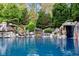 Expansive pool surrounded by natural rock formations and greenery at 110 Bywater Way, Chapel Hill, NC 27516